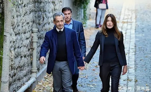 萨科齐夫妇神情凝重准备出发